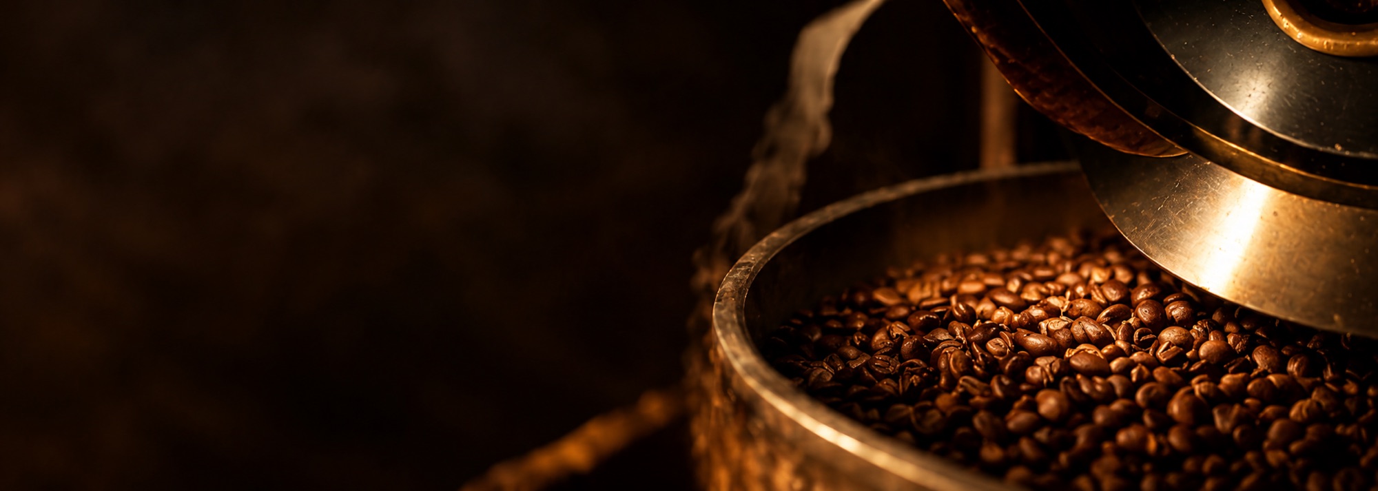 Freshly roasted coffee beans in a brass roaster